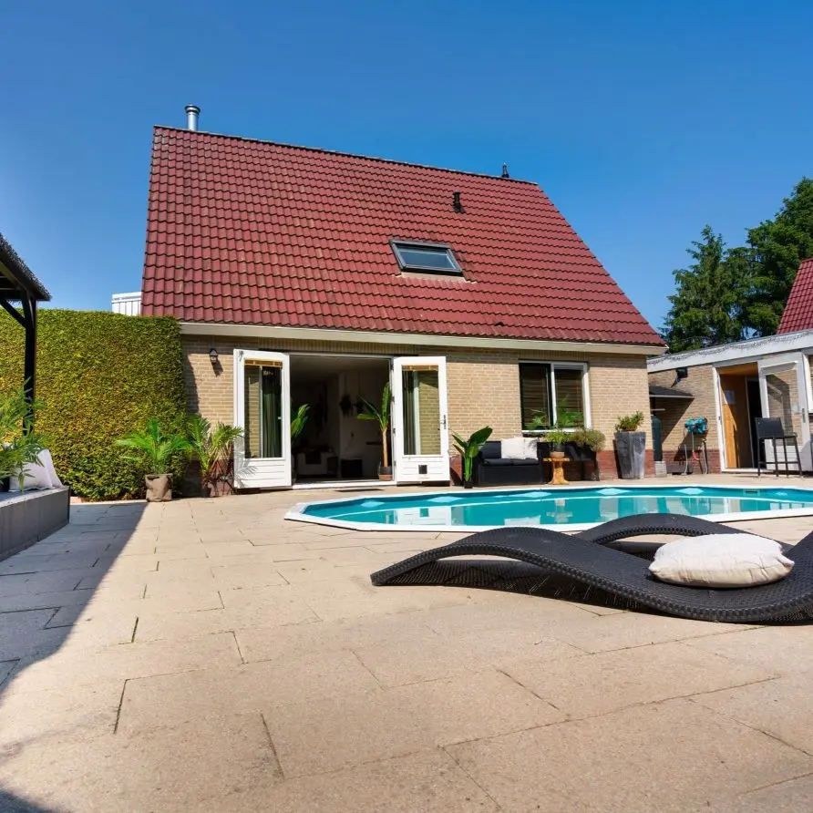 Terrace with swimming pool of a country house at Bungalowpark Boerhaarsveld